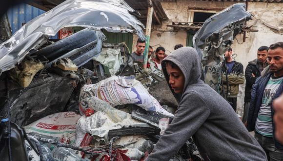 Un joven palestino inspecciona un accidente automovilístico tras un bombardeo israelí en Rafah, en el sur de la Franja de Gaza, el 8 de enero de 2024, en medio de continuas batallas entre Israel y el grupo militante Hamás. (Foto de AFP)