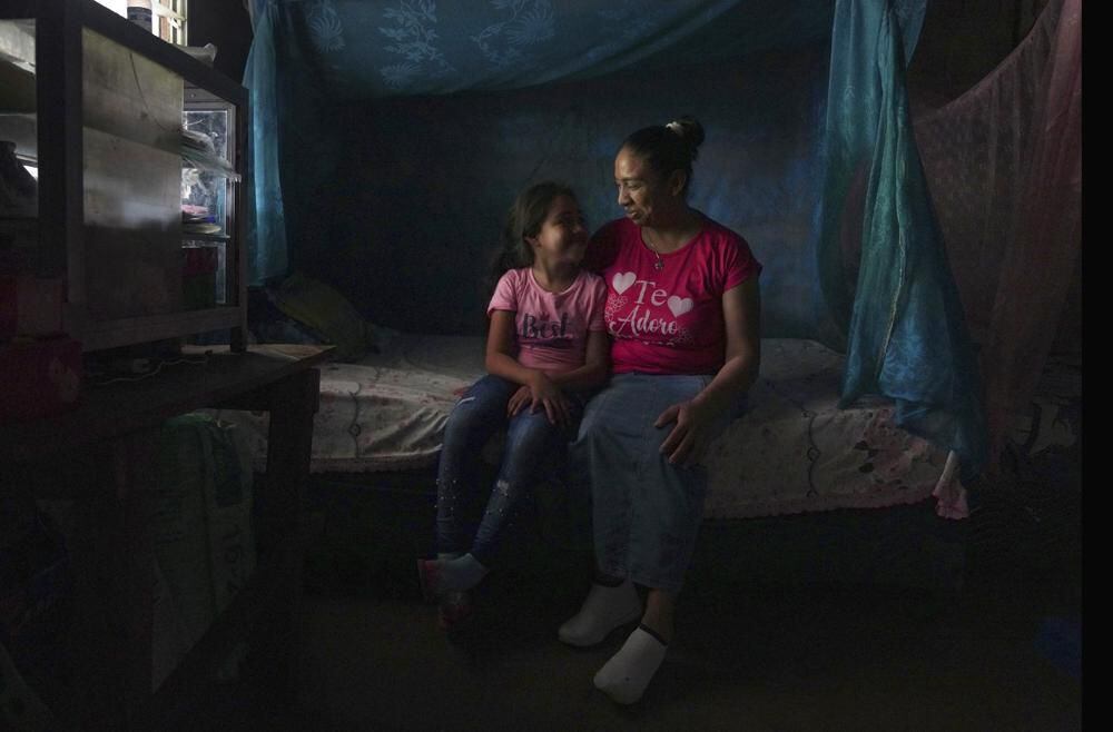 Mariana López photographed with her seven-year-old daughter at her home in Ahuachapán, El Salvador.