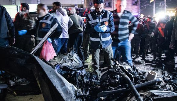 Rescatistas revisan los restos de un automóvil en el lugar de la explosión de una bomba en la ciudad de Azaz, en el norte de Siria, la madrugada del 31 de marzo de 2024. (Foto de Bakr ALKASEM / AFP)