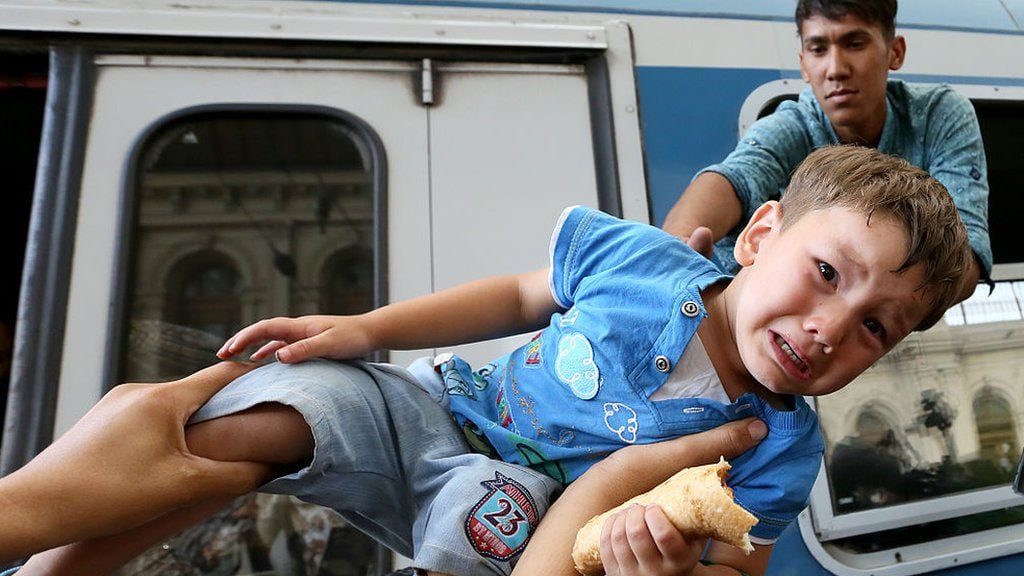 Migrants desperate to board a train during the refugee crisis in Budapest in 2015. (GETTY IMAGES)