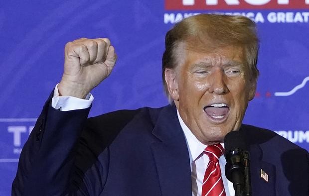 Republican presidential hopeful Donald Trump raises his fist while speaking at a campaign event in Concord, New Hampshire, on January 19, 2024. (Photo by TIMOTHY A. CLARY / AFP).