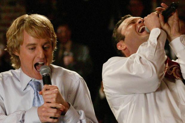 John and Jeremy, in shirts, singing at a crashed wedding (Photo: New Line Cinema)