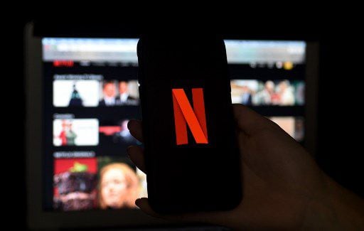 In this photo illustration, computer and mobile phone screens display the Netflix logo on March 31, 2020 in Arlington, Virginia.  Photo: Olivier DOULIERY - AFP Olivier DOULIERY / AFP