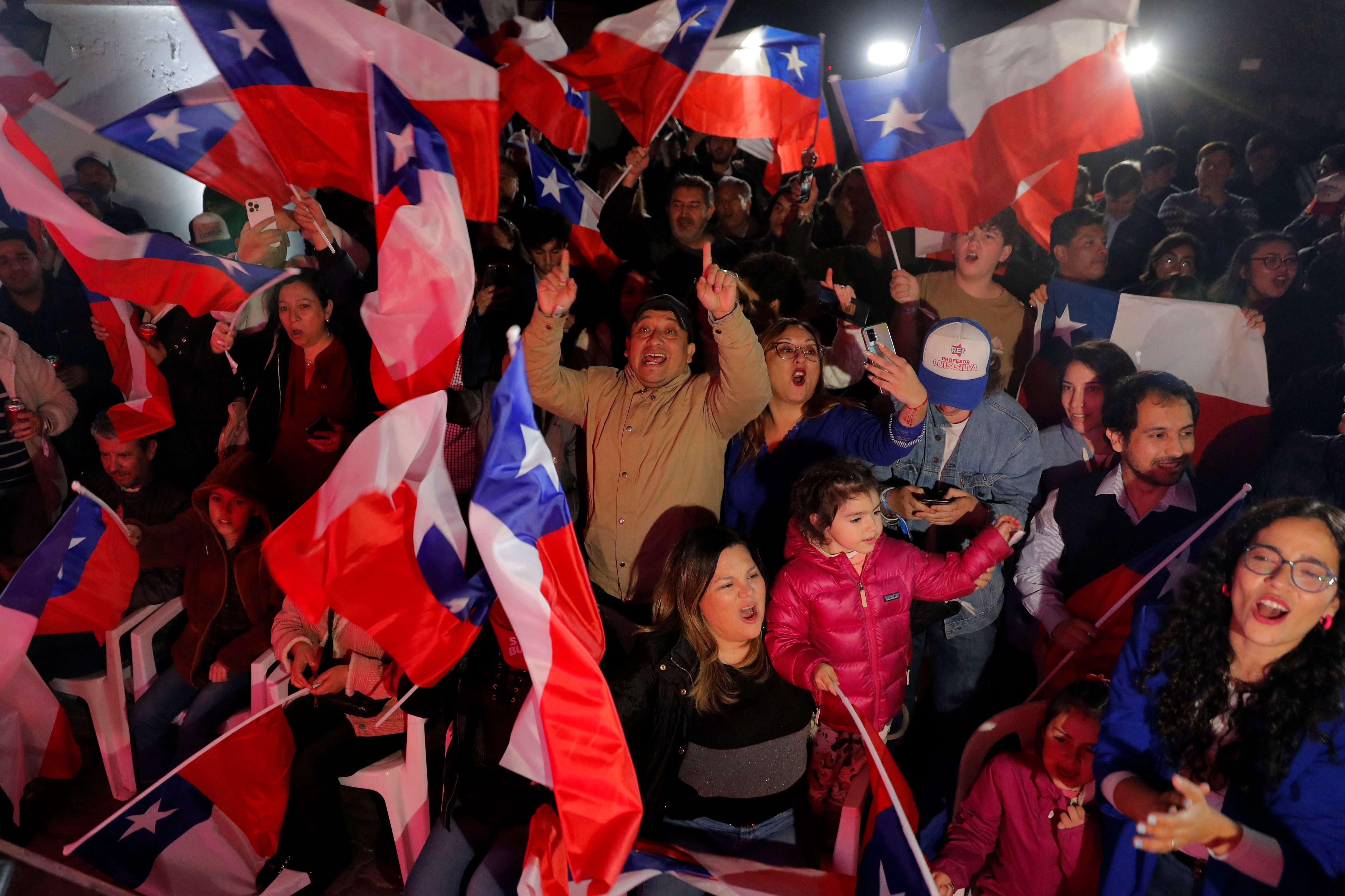 Supporters of the far-right Republican Party celebrate the victory of their candidates during an election to elect members of Chile's Constitutional Council.  (Photo by JAVIER TORRES / AFP).