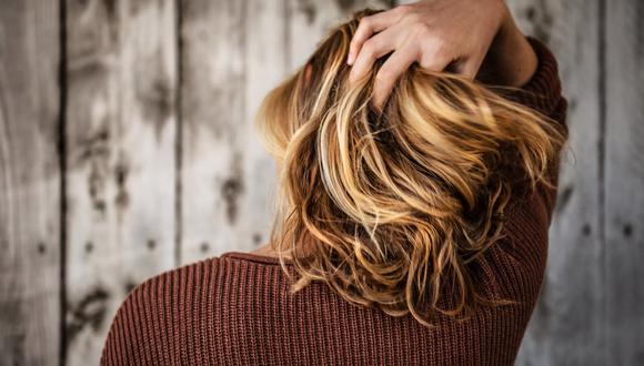 Una mujer agarrándose su cabello. | Imagen referencial: Tim Mossholder / Unsplash