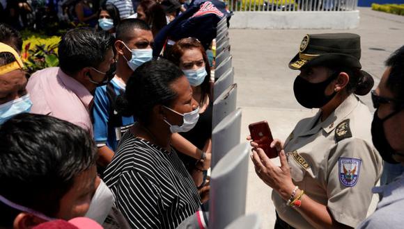 Familiares de reclusos hablan con un oficial de policía mientras esperan afuera de una morgue para identificar a los muertos luego de que estallara un motín en la prisión Penitenciaria del Litoral en Guayaquil, Ecuador. (Foto: REUTERS / Santiago Arcos).