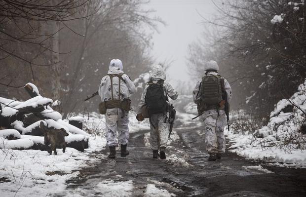 Ukrainian soldiers walk in the line of separation of pro-Russian rebels near Katerinivka in the Donetsk region of Ukraine