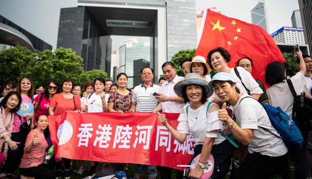 La manifestación del sábado fue clave para que se puedan congregar seguidores a favor del gobierno y la policía. Las personas agitaron banderas chinas y enviaron mensajes a través de pancartas. (Foto: AFP)
