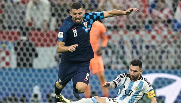 Croatia's midfielder #08 Mateo Kovacic is challenged by Argentina's forward #10 Lionel Messi during the Qatar 2022 World Cup football semi-final match between Argentina and Croatia at Lusail Stadium in Lusail, north of Doha on December 13, 2022. (Photo by JUAN MABROMATA / AFP)