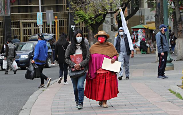 Ciudadanos caminan el 28 de setiembre de 2020 en La Paz (Bolivia). El deseo de los bolivianos de terminar con la incertidumbre y elegir de una vez a un nuevo presidente es más fuerte que el miedo al coronavirus. (EFE/Martín Alipaz).