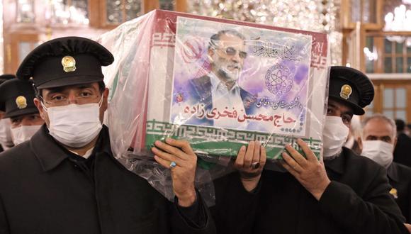 Los trabajadores del santuario sagrado del Imam Reza llevan el ataúd del principal científico nuclear de Irán Mohsen Fakhrizadeh, quien fue asesinado el viernes. (AFP).