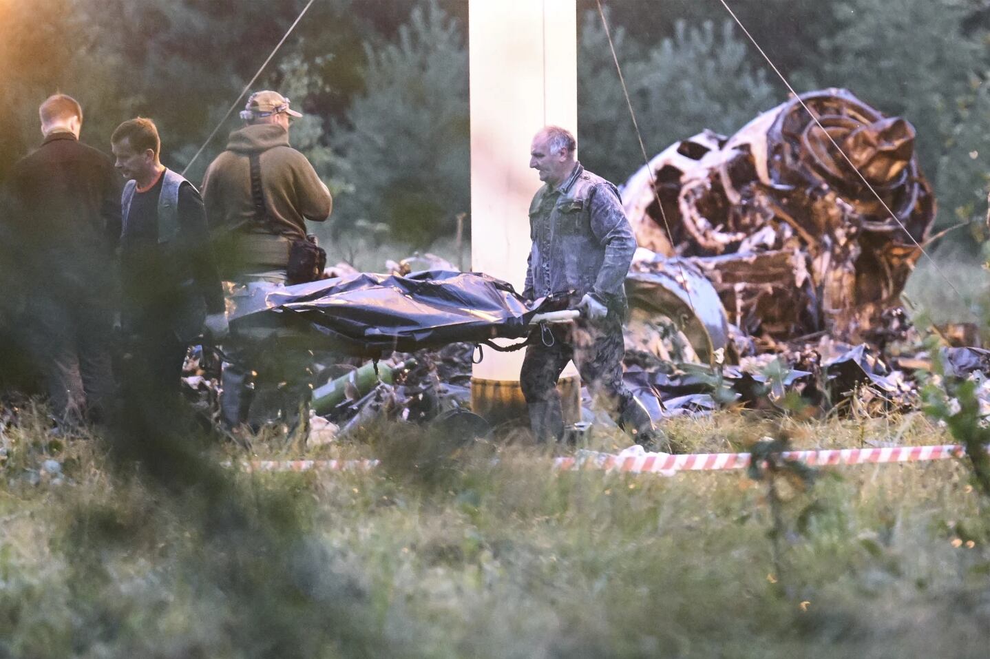 A body is removed from the spot where the private plane crashed.  (Photo: AP).