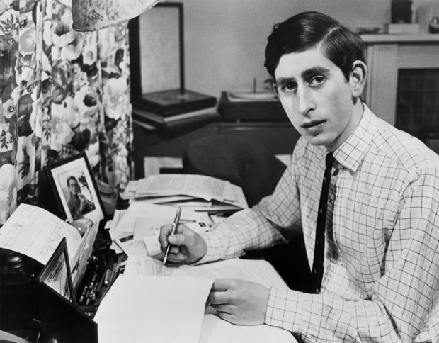 Photograph dated June 19, 1969, showing Crown Prince Charles sitting at his desk in Cambridge, during his studies.  (Photo by CENTRAL PRESS PHOTO LTD / AFP).