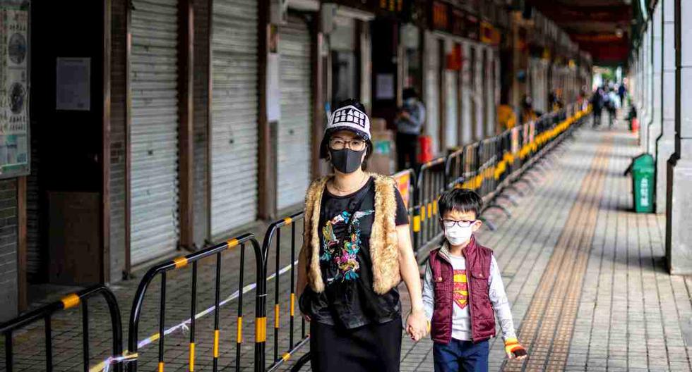 La gente pasa frente a tiendas vacías en Guangzhou, china, debido al coronavirus. (Foto: EFE/EPA/ALEX PLAVEVSKI)