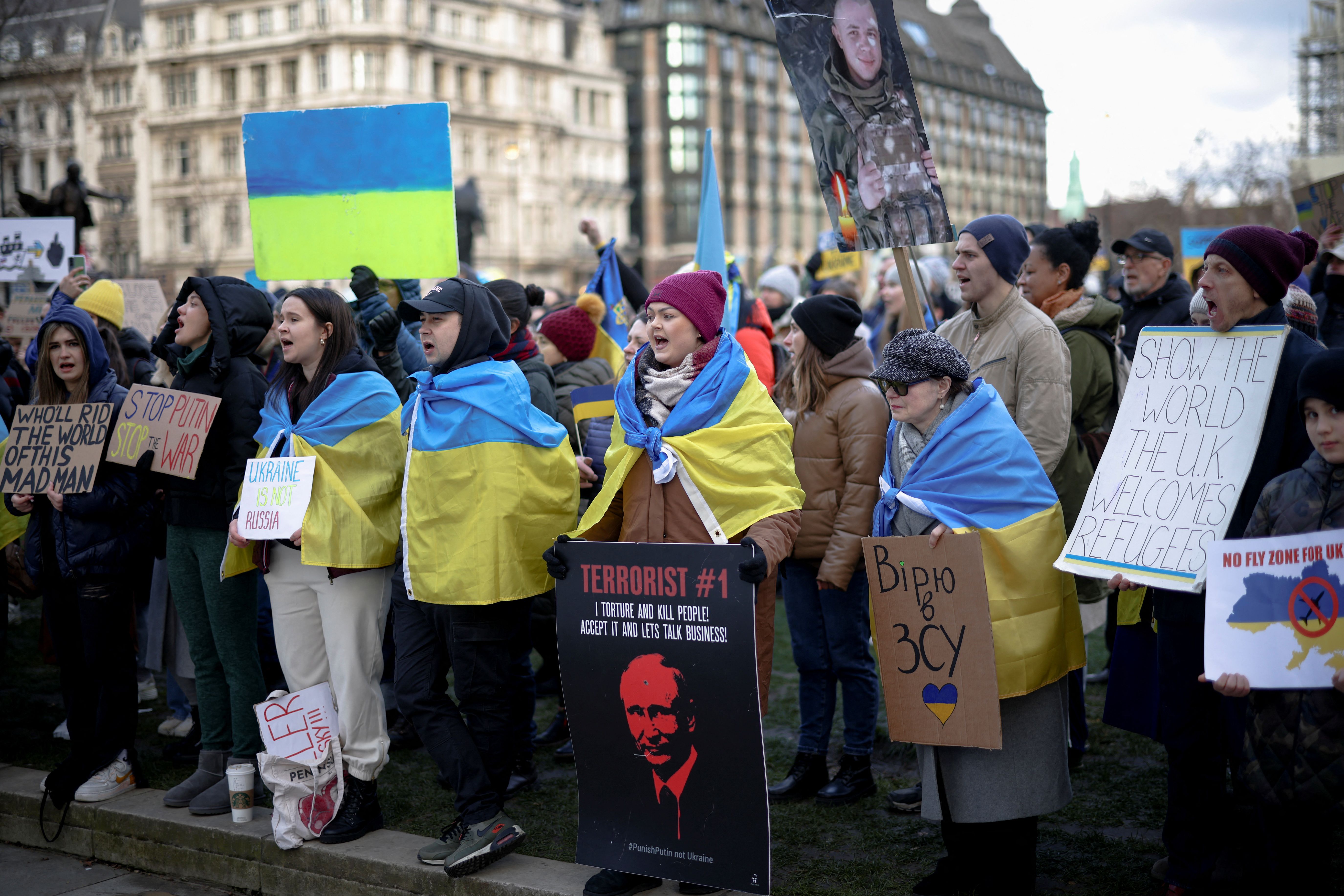 People attend a protest against the Russian invasion of the Ukraine, in Parliament Square in London, Britain.  (REUTERS/Henry Nicholls).