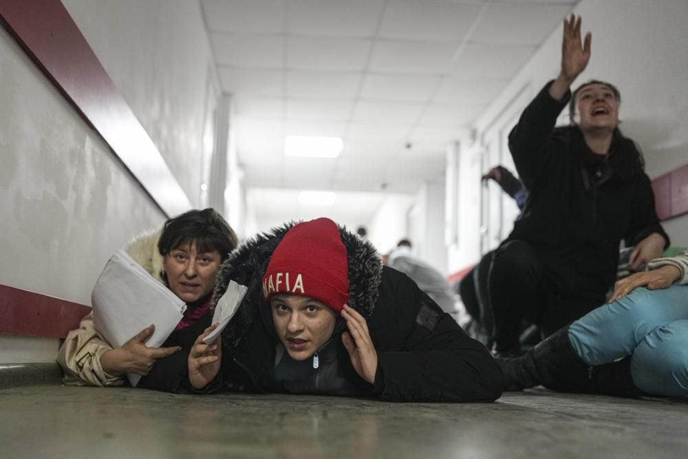 People lie on the floor of a hospital during the shelling by Russian forces in Mariupol, Ukraine, on Friday, March 4, 2022. (AP Photo/Evgeniy Maloletka)