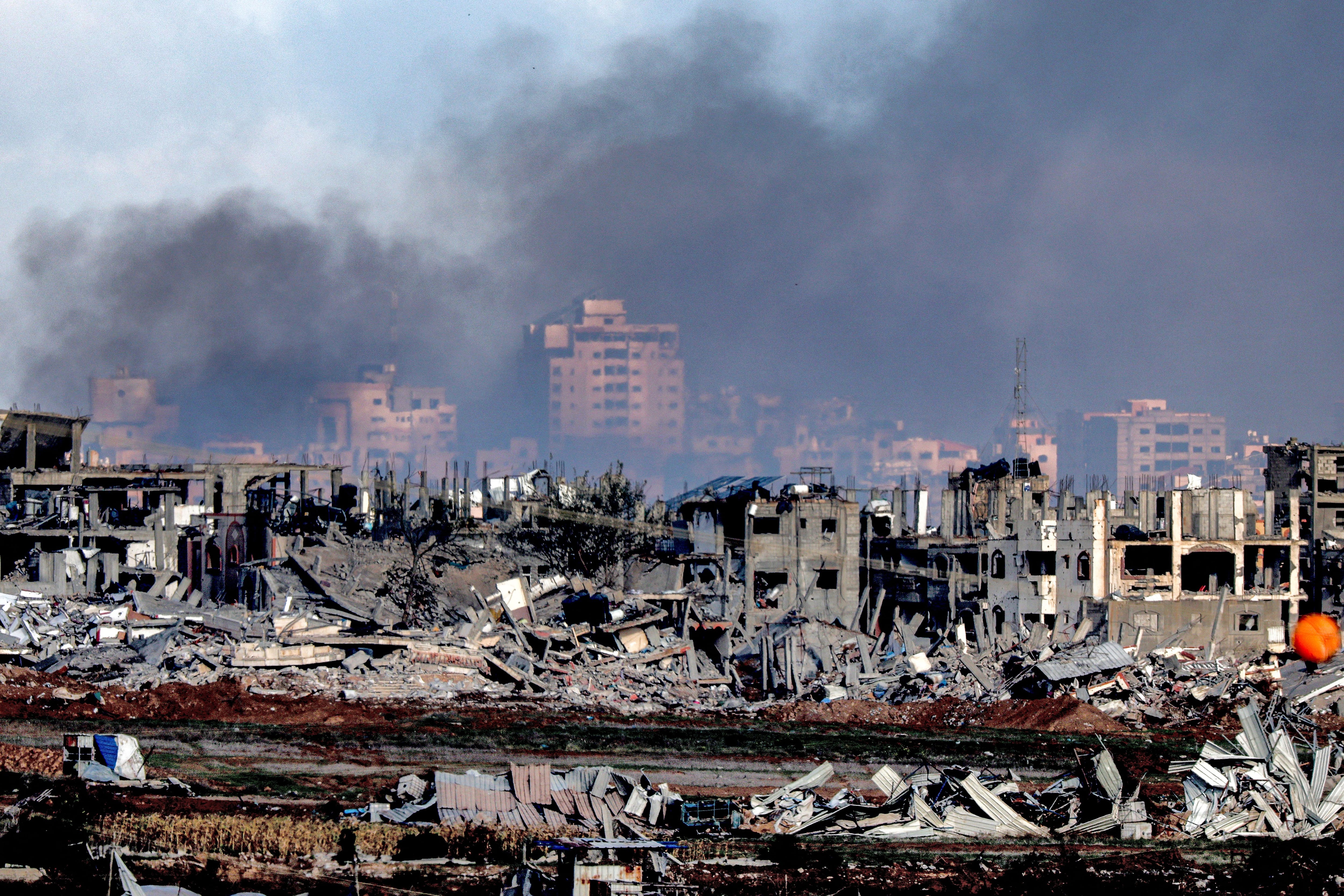 This photo taken on January 3, 2024 shows a view of buildings destroyed by Israeli shelling in the center of the Gaza Strip.  (Photo by JACK GUEZ/AFP).