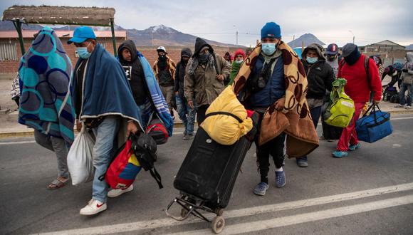 Migrantes venezolanos caminan hacia Iquique desde Colchane, Chile, luego de cruzar desde la frontera con Bolivia, el 23 de septiembre de 2021. (MARTIN BERNETTI / AFP).