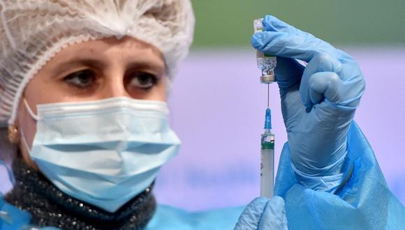 Personal sanitario prepara una dosis de la vacuna Oxford / AstraZeneca contra la enfermedad del coronavirus en Kiev, Ucrania, el 16 de marzo de 2021, (Foto de Sergei SUPINSKY / AFP).