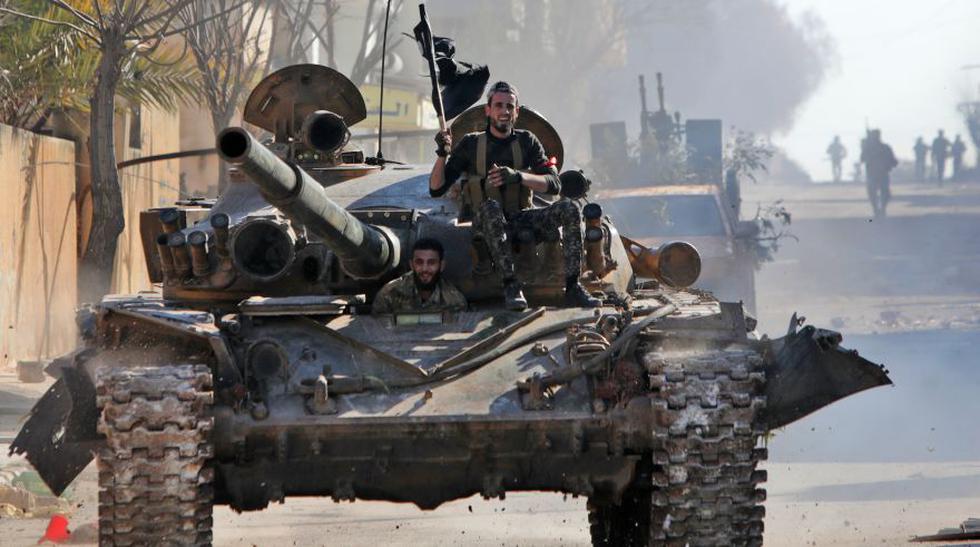 Combatientes sirios respaldados por Turquía viajan en un tanque en la ciudad de Saraqib. Las grandes pérdidas se producen después de semanas de crecientes tensiones entre Turquía y Rusia, un firme aliado de Siria. (AFP).