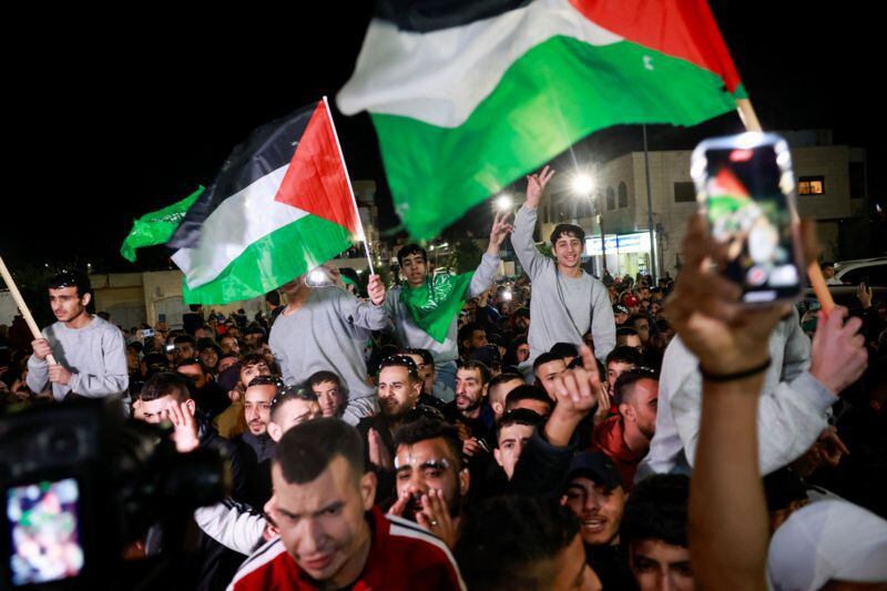 Palestinians celebrated the arrival of 39 Palestinians, several of them teenagers.  (Reuters).