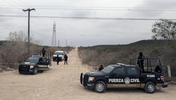 La policía mexicana custodia el sitio donde cuatro hombres fueron asesinados en una carretera en Pesquería, Nuevo León, México, el 19 de febrero de 2019. (Foto de Julio Cesar AGUILAR / AFP)