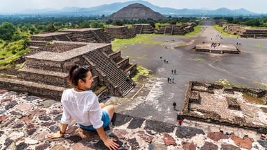 Tourism in Mexico - young adult tourist at ancient pyramids