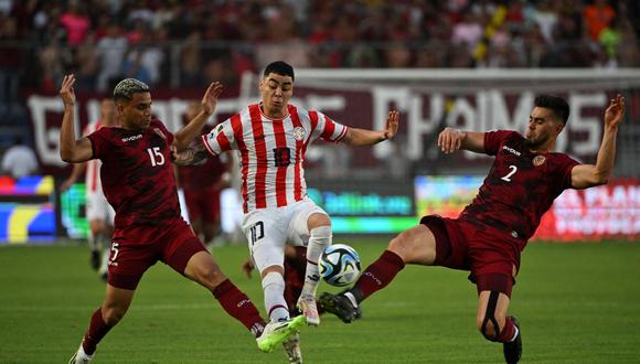Paraguay's midfielder Miguel Almiron (C) fights for the ball with Venezuela's defender Miguel Navarro (L) and defender Wilker Angel during the 2026 FIFA World Cup South American qualifiers football match between Venezuela and Paraguay, at the Monumental stadium in Maturin, Venezuela, on September 12, 2023. (Photo by Yuri CORTEZ / AFP)