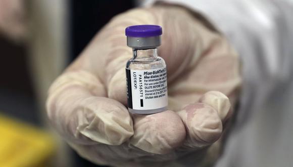 A medical staffer holds a vial of the Pfizer-BioNTech COVID-19 vaccine during a nationwide vaccination program at the American University Medical Center in Beirut, Lebanon, Sunday, Feb. 14, 2021. (AP Photo / Bilal Hussein)