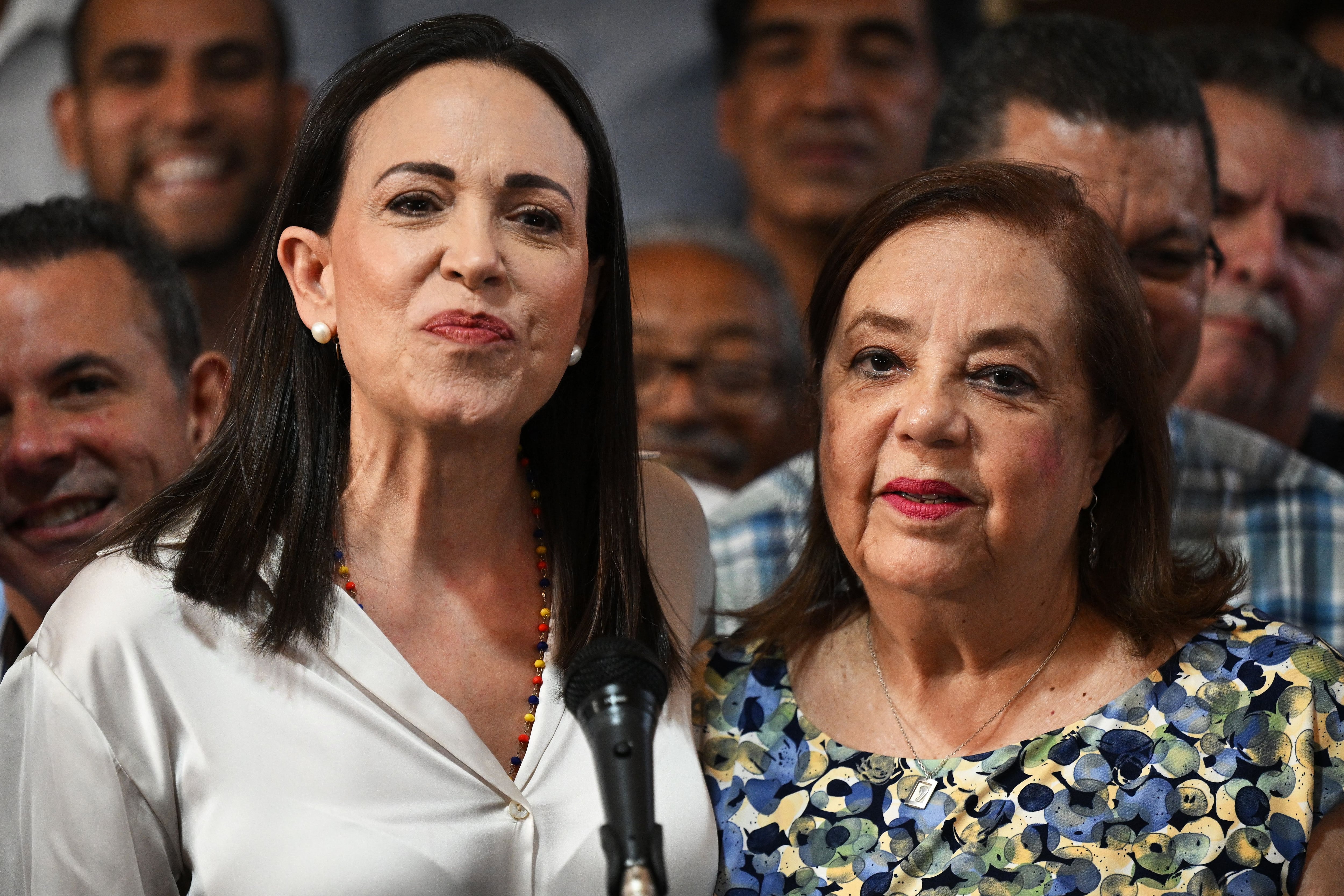 Venezuelan opposition leader María Corina Machado (left) gestures with her replacement in the upcoming presidential elections, Corina Yoris.  (Photo by Federico Parra/AFP).