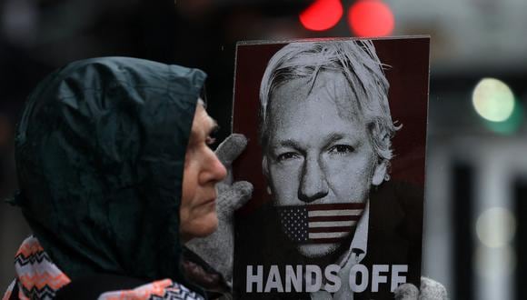 Simpatizantes de Julian Assange sostienen pancartas mientras protestan frente a los Tribunales Reales de Justicia en Londres el 21 de febrero del 2024. (Daniel LEAL / AFP).