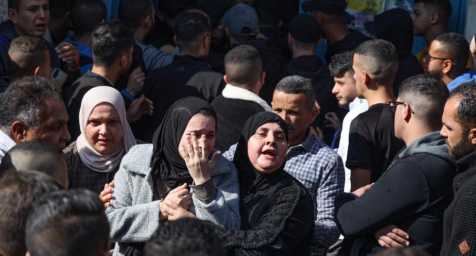 Familiares de uno de los nueve palestinos fallecidos lloran en el campo de refugiados de Yenín tras la incursión militar israelí. (Photo by JAAFAR ASHTIYEH / AFP)
