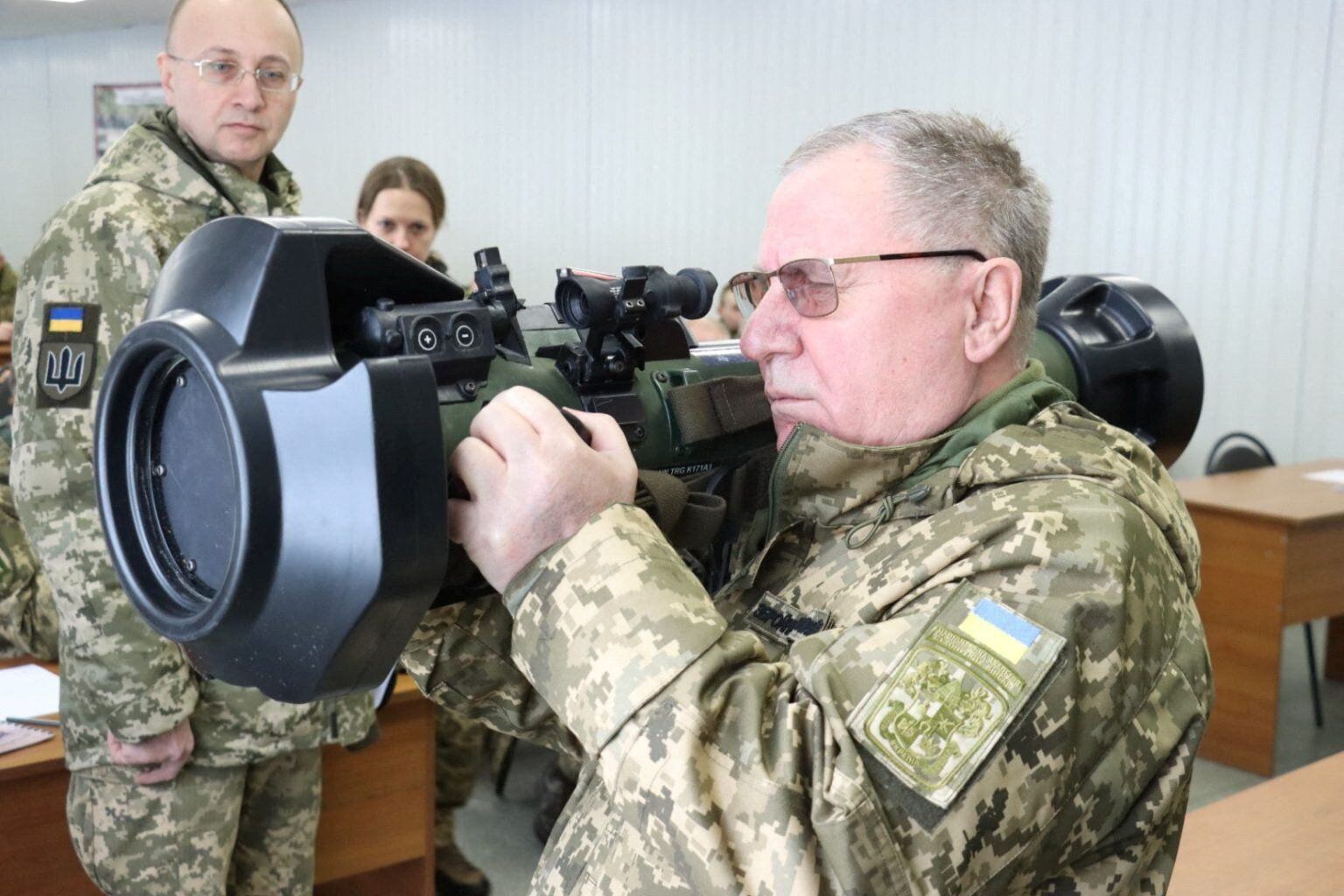 Ukrainian servicemen review a powerful anti-tank weapon provided by the British Army.  REUTERS