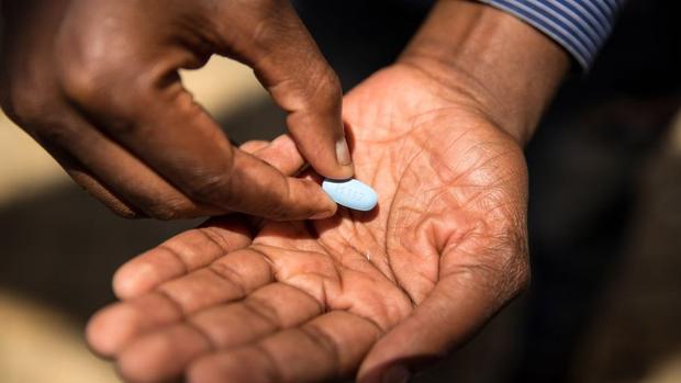 Person holding an HIV preventive pill.