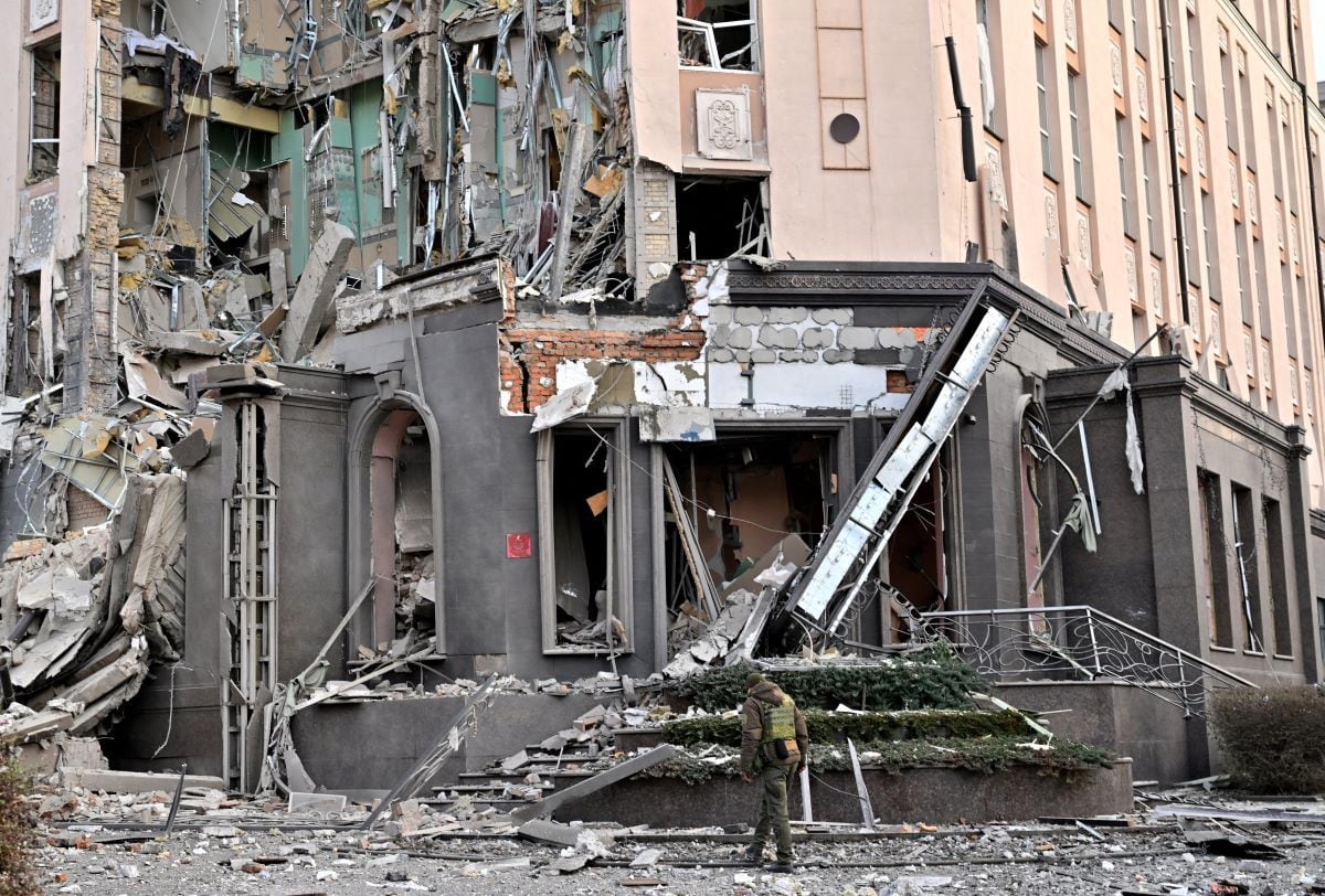 A soldier walks near a hotel that was partially destroyed by a Russian attack in kyiv, the capital of Ukraine, on December 31, 2022. (Sergei SUPINSKY / AFP).