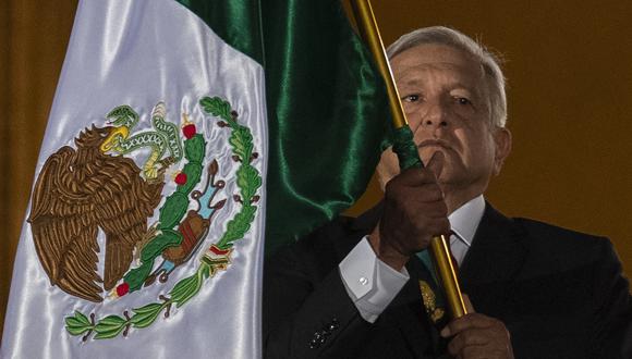 Mexican President Andres Manuel Lopez Obrador waves a Mexican flag on the main balcony of the National Palace during the ceremony "The Shout" (El Grito) marking the start of Independence Day celebrations in Mexico City on September 15, 2019. (Photo by PEDRO PARDO / AFP)