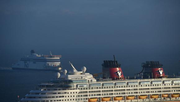 Un ferry P&O llega cuando el crucero Disney Magic se ve atracado en el puerto de Dover en la costa sur de Inglaterra, el 31 de diciembre de 2020. (JUSTIN TALLIS / AFP).
