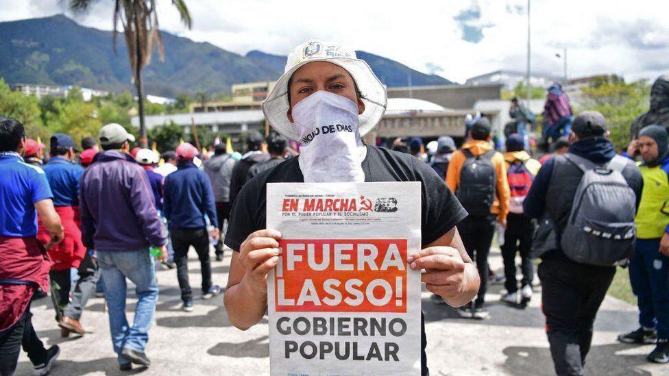 One of the protesters in Quito shows the front page of a university communist newspaper.  (GETTY IMAGES)