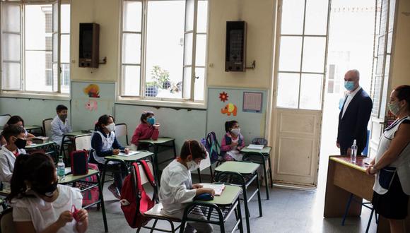 El alcalde Horacio Rodríguez Larreta mira a los escolares mientras tomaban clase en una escuela pública en su primer día de clases en Buenos Aires el 17 de febrero de 2021, en medio de la pandemia de coronavirus. (Foto: AFP).