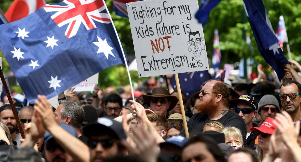 La gente sostiene pancartas durante una manifestación contra el bloqueo por coronavirus Covid-19 y las medidas de vacunación en Melbourne, Australia, el 20 de noviembre de 2021. (William WEST / AFP).