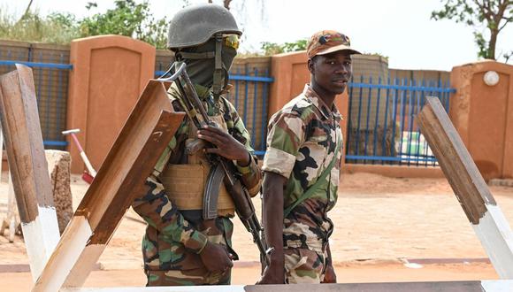 Soldados nigerinos hacen guardia mientras los partidarios del Consejo Nacional de Salvaguardia de la Patria (CNSP) de Níger protestan frente a la base aérea de Níger y francesa en Niamey el 30 de agosto de 2023 para exigir la salida del ejército francés de Níger | Foto: AFP