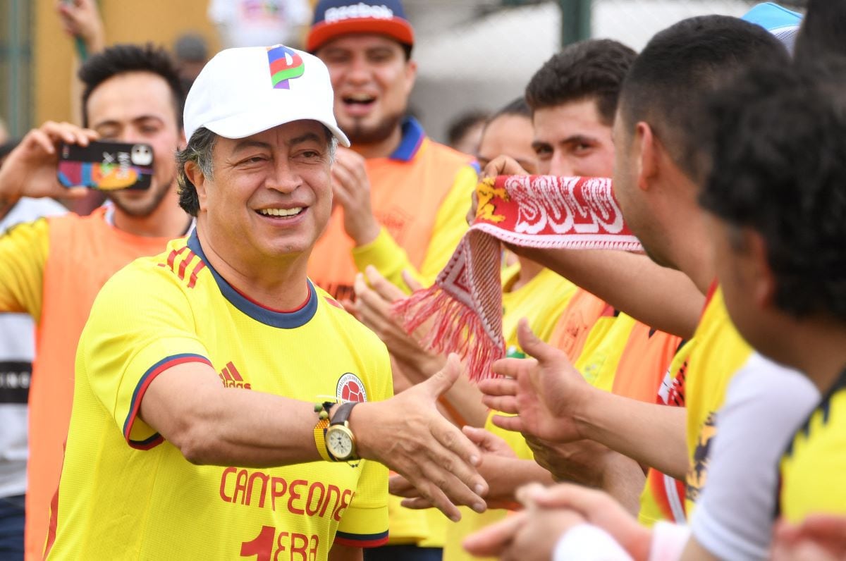 In this June 5, 2022 photo, Colombia's leftist presidential candidate Gustavo Petro greets supporters before a friendly soccer match in Bogota.  (DANIEL MUÑOZ / AFP).