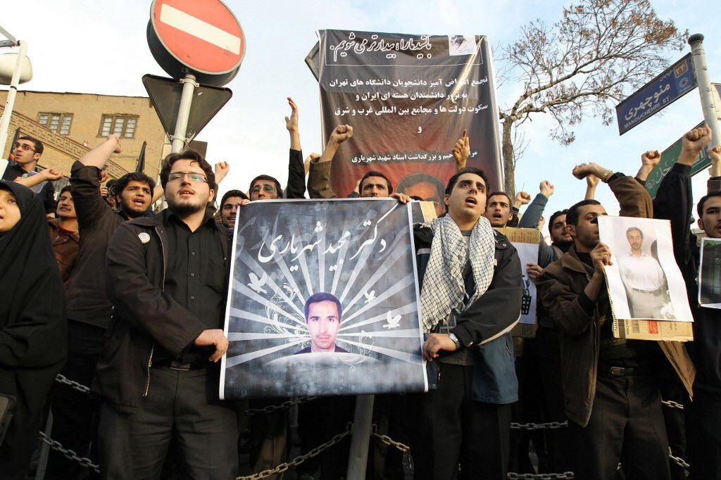 Protesters carry portraits of nuclear scientist Majid Shahriari during a protest outside the British embassy in Tehran on December 12, 2010. 