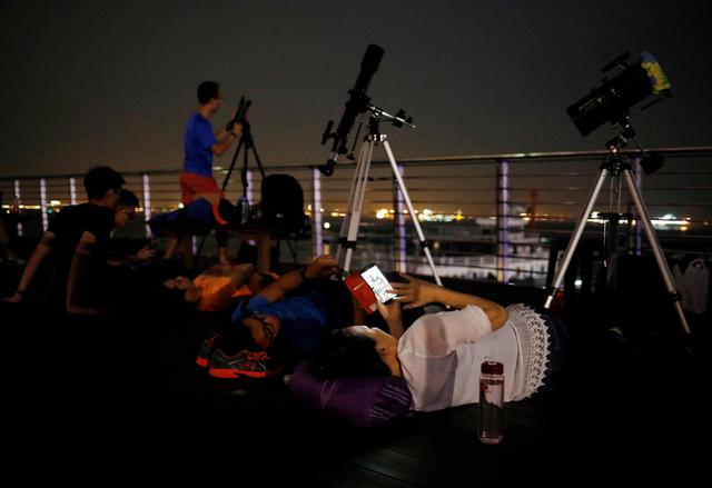 Aficionados esperando el eclipse luna de sangre en Singapur. (Foto: Reuters)