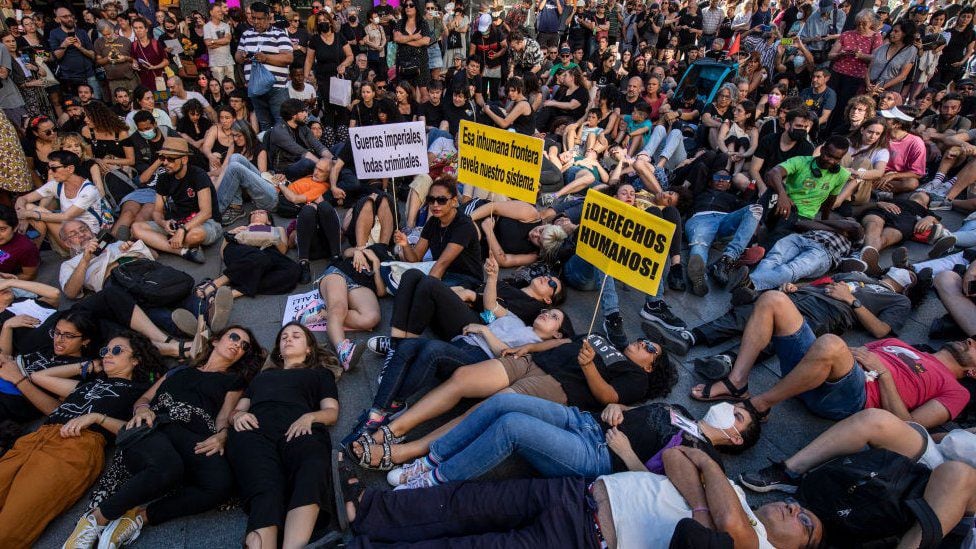 During protests in Spain this weekend, dozens of people lay on the ground imitating images of migrants stacked on the Melilla fence that have been broadcast since Friday.  (GETTY IMAGES).