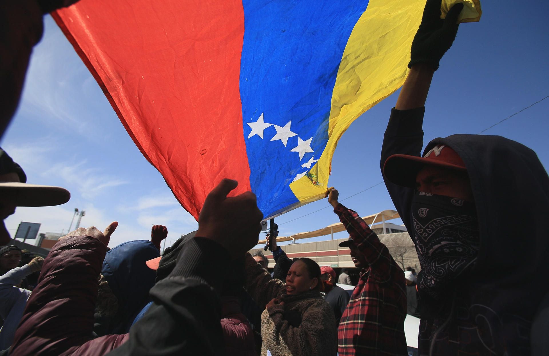 A group of Venezuelan migrants and relatives of people who died in a fire in a shelter protest in front of the National Institute of Migration (INM) in Ciudad Juárez.  (EFE/Luis Torres).