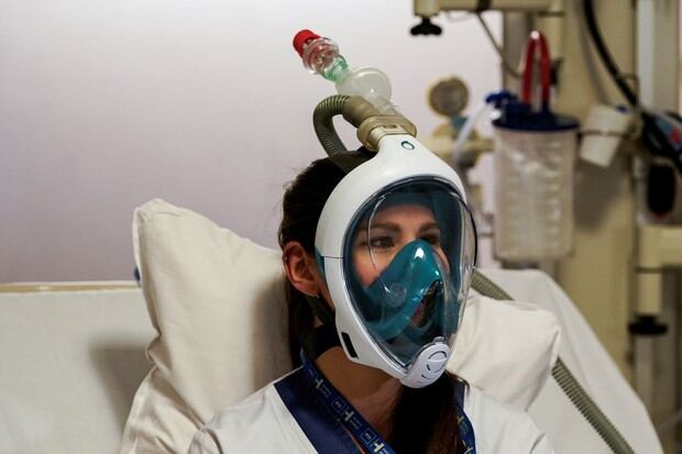 Un trabajador médico prueba una máscara de snorkel Decathlon mejorada con accesorios de válvulas respiratorias impresas en 3D en el Hospital Erasme de Bruselas (Foto: AFP)