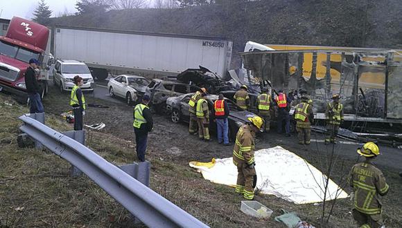 Rescue workers look over the scene on I-77 where approximately 75 vehicles were involved in an accident in Carroll County, Virginia near the North Carolina state line in this March 31, 2013 photo courtesy of WXII12-TV. Three people are reported dead and 