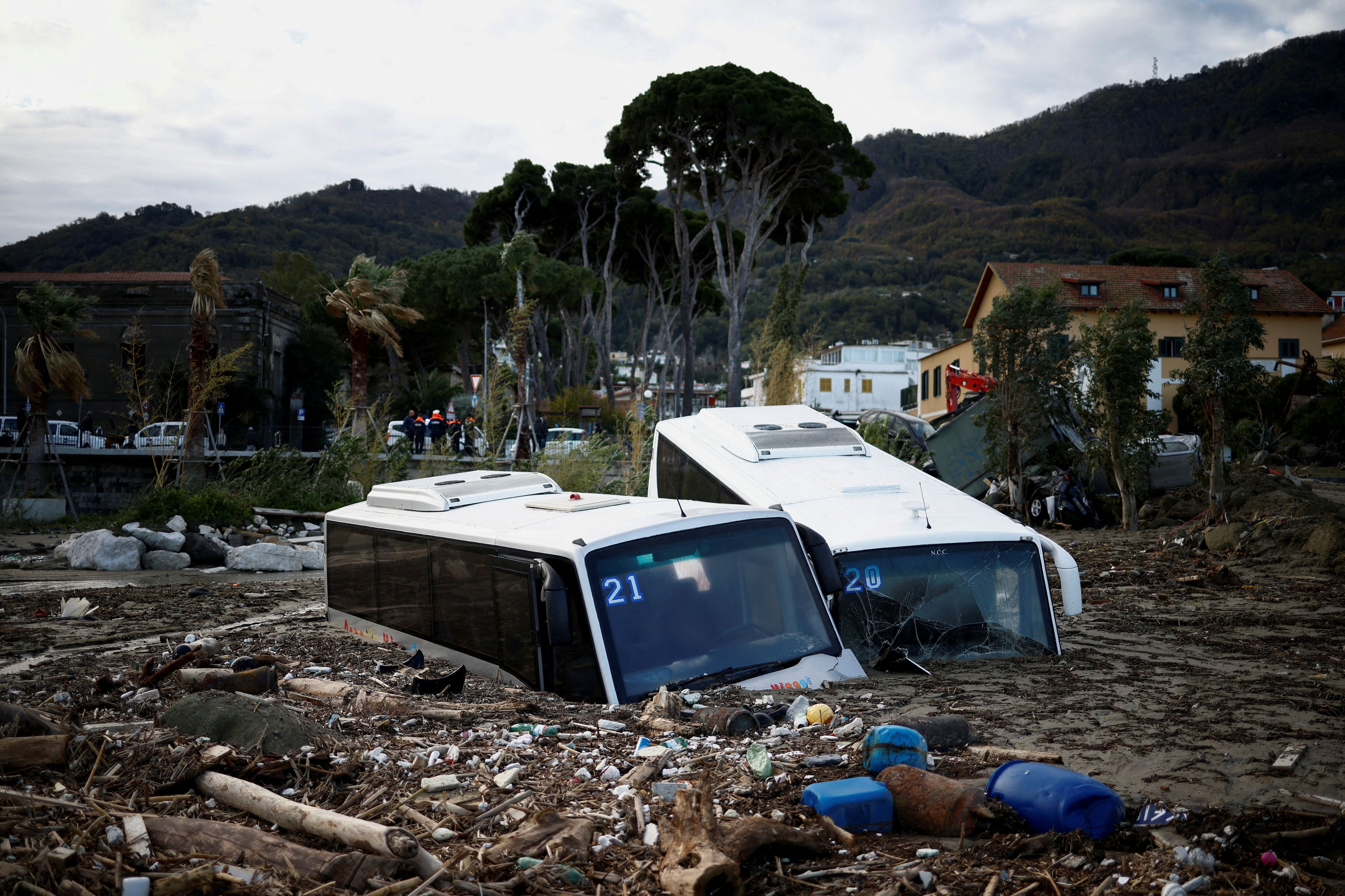 Damaged buses lie among the rubble after a landslide on the Italian holiday island of Ischia, Italy.