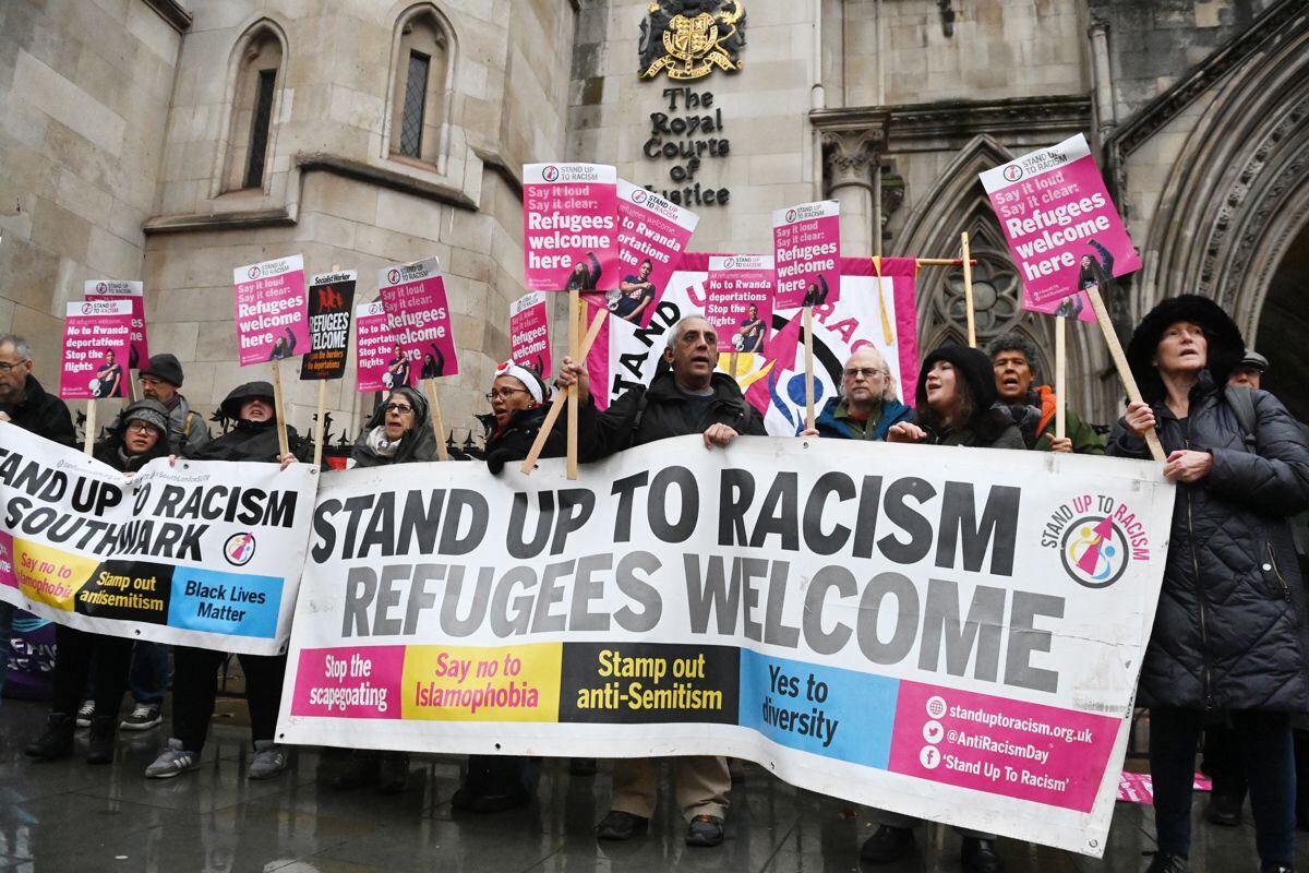 Members of the 'Stand up to Racism' protest group demonstrate against the deportations of refugees to Rwanda at the High Court in London, Great Britain, on December 19, 2022. (Photo by EFE/EPA/NEIL HALL)